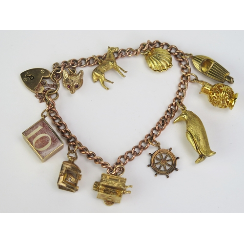 109 - A 9ct Gold Charm Bracelet with ten hallmarked charms including an articulated scallop shell with unt... 