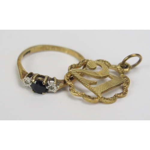 117 - A 9ct Gold 21st Birthday Charm (hallmarked, 1.51g) and a 9ct gold, sapphire and diamond three stone ... 