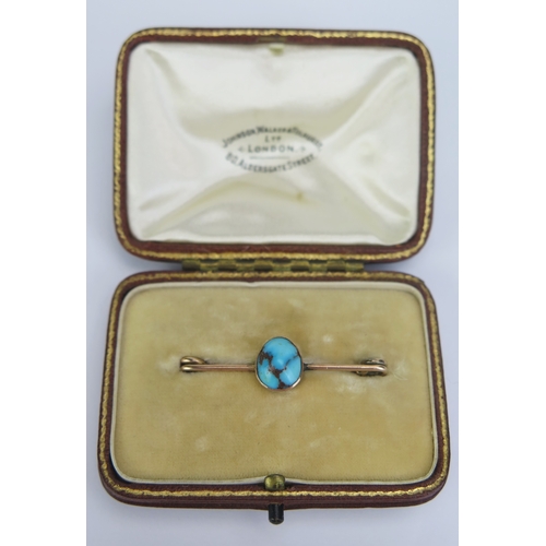 131 - A Precious Yellow metal and Turquoise Brooch in a Johnson, Walker & Tolhurst fitted box, 39.5mm wide... 