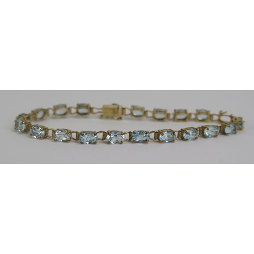 134 - A 9ct Gold and Blue Topaz or Aqua Marine Bracelet, 7.75