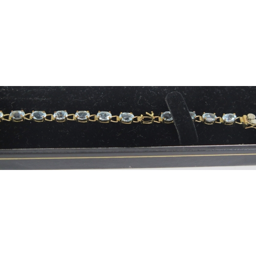 134 - A 9ct Gold and Blue Topaz or Aqua Marine Bracelet, 7.75