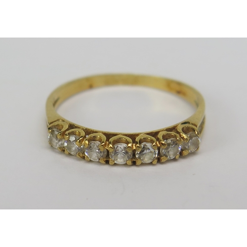 138 - An 18ct Gold and Paste Seven Stone Ring, size M.5, stamped 750, 1.78g