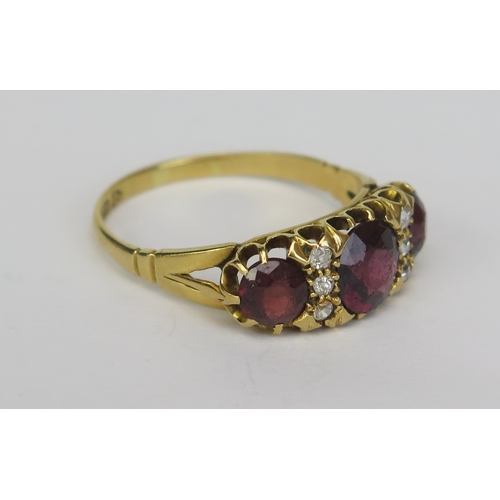 144 - An 18ct Gold, Garnet and White Stone Ring, size P.25, Chester hallmarks, 3.69g