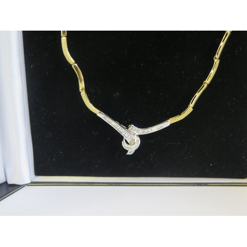 179 - An 18ct Gold and Baguette Cut Diamond Necklace with alternate brushed and polished gold links and a ... 