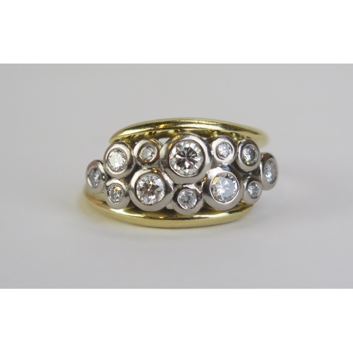 A Modern 18ct and Diamond Ring set with twelve brilliant round cut stones in a rub over precious white metal setting, largest c. 3.9mm, Birmingham hallmarks, maker WBB, size P.25, 10.5g