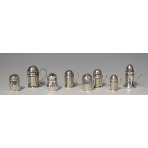 574 - A collection of silver miniature pepperettes in the form of flour sifters, various makers and dates,... 