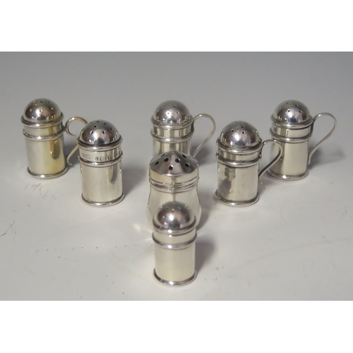 575 - A collection of silver miniature pepperettes in the form of flour sifters, various makers and dates,... 