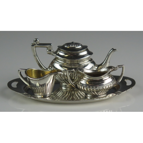 592 - An Elizabeth II silver miniature matched three-piece tea set, various makers and dates of oval form ... 