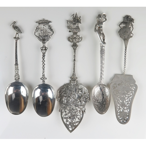 612 - A collection of five assorted silver spoons and slices, all with decorative stems and terminals, tot... 