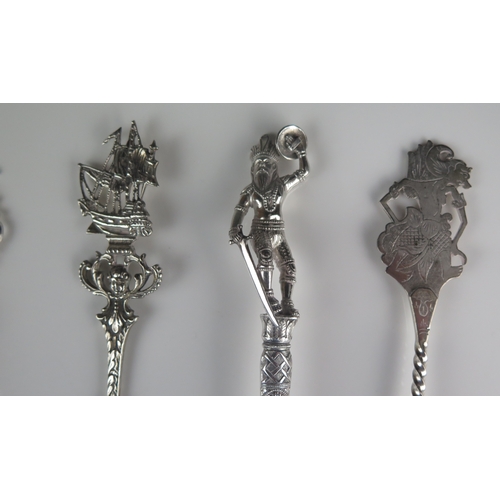 612 - A collection of five assorted silver spoons and slices, all with decorative stems and terminals, tot... 