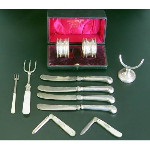 637 - To silver bladed folding fruit knives, a pair of silver napkin rings, silver handled butter knives e... 