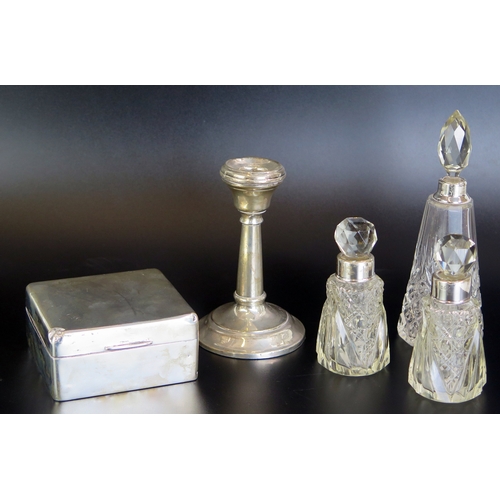 638 - A mixed collection of silver wares includes cigarette box, candlestick, and three clear glass and si... 