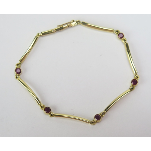 64 - An 18ct Gold and Ruby Bracelet with five c. 2.95mm rub over set stones, London hallmarks, 6.75