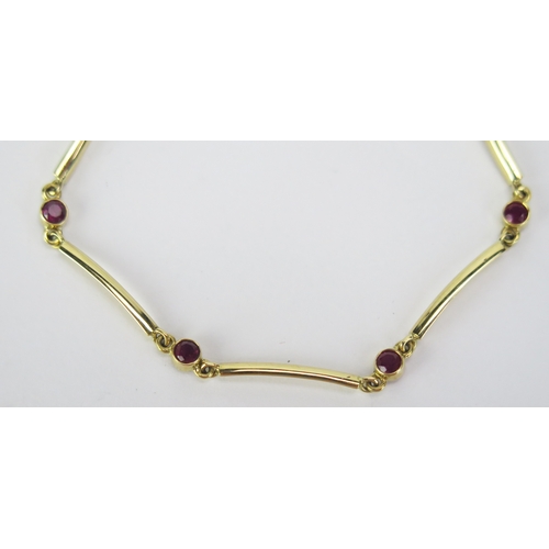 64 - An 18ct Gold and Ruby Bracelet with five c. 2.95mm rub over set stones, London hallmarks, 6.75