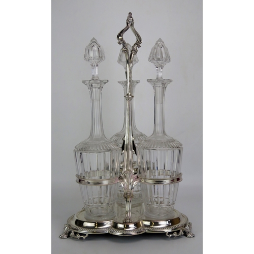 642 - A silver plated decanter stand of trefoil outline, with beaded stem and loop carrying handle, contai... 