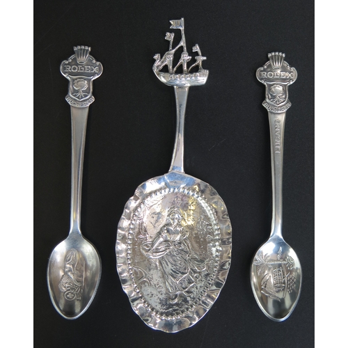 652 - A continental silver caddy spoon, bears import marks, the bowl decorated with a farming girl with sa... 