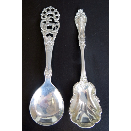 657 - Two continental silver preserve spoons, total weight of silver 45gms, 1.49ozs