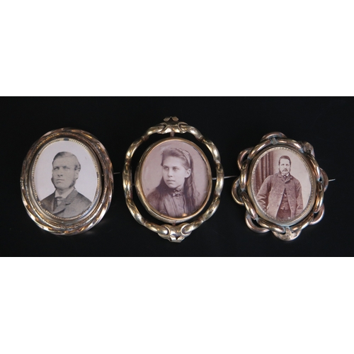 667 - Three gilt metal swivel brooches of oval outline, with photographs to either sides.