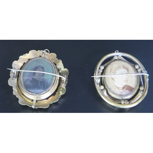 668 - Two gilt metal memorial swivel brooches of oval outline, with photographs to either sides