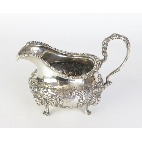 673 - A William IV Irish silver cream jug, maker James Le Bas, Dublin, 1830,  crested, of circular form wi... 