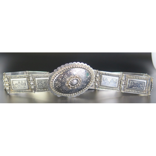 692 - A late 19th century Eastern silver and niello decorated belt, with oval domed shaped clasp with rect... 