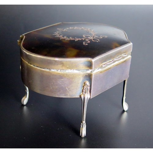 699 - A sterling silver and tortoiseshell jewellery casket, of cartouche-shaped outline, raised on four sl... 