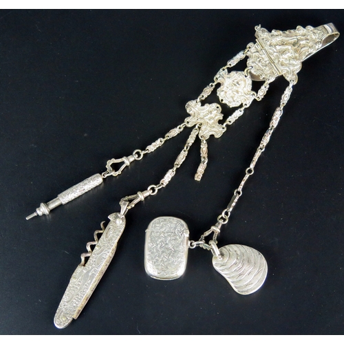 709 - *WITHDRAWN* A silver plated chatelaine with three chain suspensions with pen knife, aide memoire, ve... 