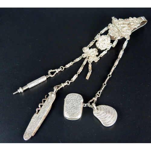 709 - *WITHDRAWN* A silver plated chatelaine with three chain suspensions with pen knife, aide memoire, ve... 