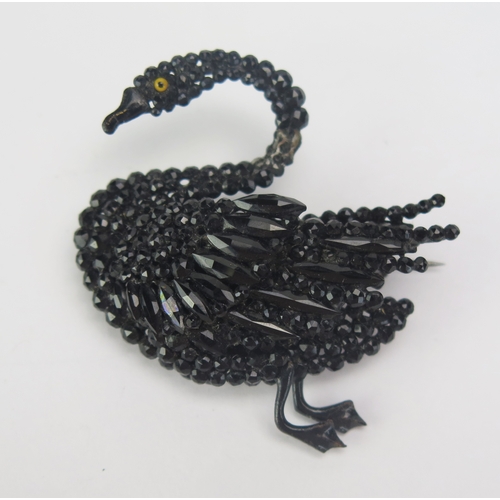 73 - A Victorian Black Glass Swan Brooch, 43.7mm wide. Some loss to neck