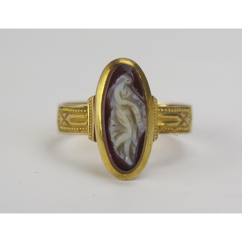 74 - A 19th Century Hardstone Cameo Ring decorated with a full length female figure in profile and in a p... 