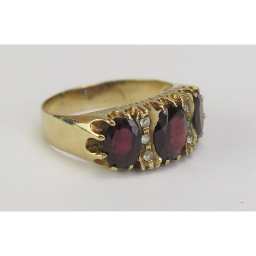 75 - A 9ct Gold, Garnet and White Stone Ring, 9.35mm wide head, Birmingham 1976, size P.25, 4.55g