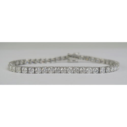 86 - An 18K White Gold and Diamond Tennis Bracelet, stamped 18K, 6.95cts of diamonds, set with 47 c. 3.5m... 