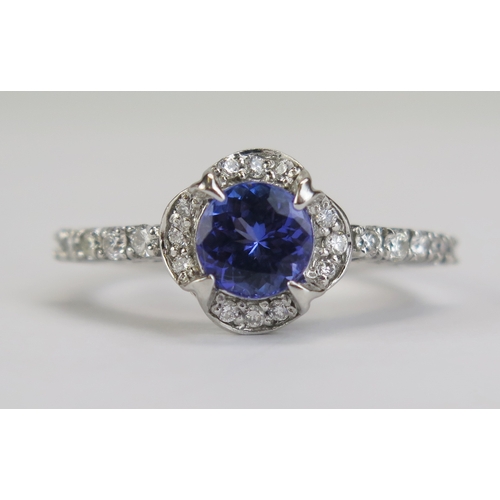 87 - A Cavill 18ct Gold, Tanzanite and Diamond Cluster Ring, c. 7mm principal stone, 11.65mm wide head wi... 