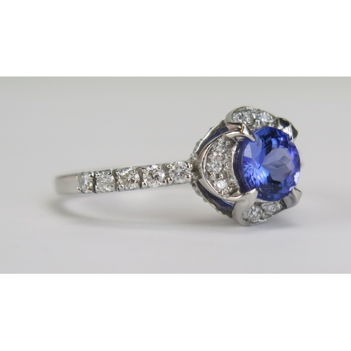 87 - A Cavill 18ct Gold, Tanzanite and Diamond Cluster Ring, c. 7mm principal stone, 11.65mm wide head wi... 