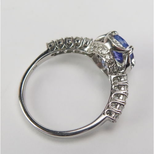 87 - A Cavill 18ct Gold, Tanzanite and Diamond Cluster Ring, c. 7mm principal stone, 11.65mm wide head wi... 