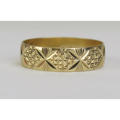 90 - A Modern 9ct Gold Patterned Wedding Band, hallmarked, B.Bros., 5.7mm wide, size t.25, 2.21g