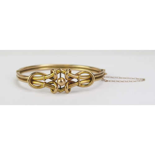 93 - A 9ct Gold 'Knotted' Hinged Bangle with safety chain, stamped 9CT and 375, early 20th century, 8.04g