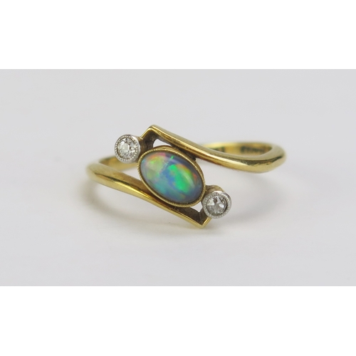 94 - An 18ct Gold and Platinum, Black Opal and Diamond Crossover Ring, 6.2x4.2mm millegrain set singlet f... 