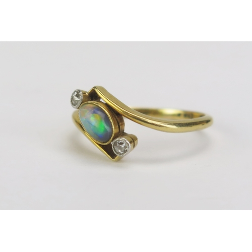 94 - An 18ct Gold and Platinum, Black Opal and Diamond Crossover Ring, 6.2x4.2mm millegrain set singlet f... 