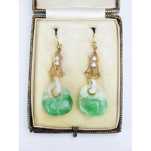 95 - A Pair of 18ct Gold and Carved Jade Pendant Earrings with sliding untested pearls to the suspensions... 