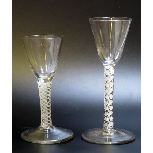 1004 - A 19th century wine glass with inverted bell-shaped bowl on an opaque twist stem and circular spread... 