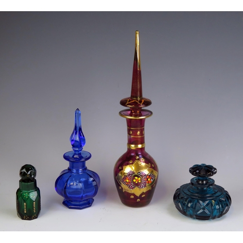 1008 - A continental ruby glass and gilt decorated scent bottle, together with three other glass scent bott... 