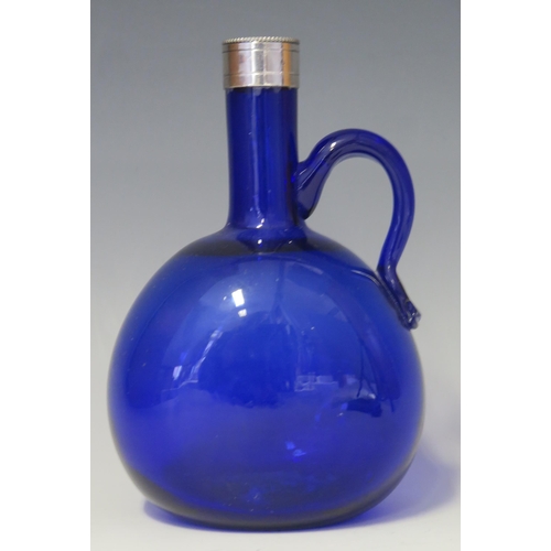 1010 - A Bristol blue glass and silver mounted with scroll handle 20cm high.