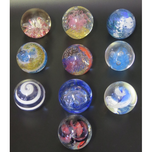 1012 - A collection of twelve assorted glass paperweights, by various manufacturers, some boxed.