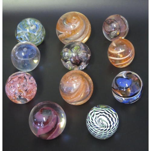 1014 - A collection of eleven assorted glass paperweights, by various manufacturers, some boxed.