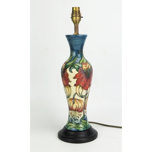 1050 - A Moorcroft pottery table lamp, of baluster form with Anna Lilly pattern decoration, mounted on a po... 