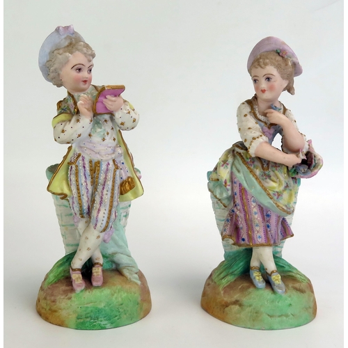 1059 - A pair of late 19th century German bisque porcelain figural spill vases with young boy and girl each... 