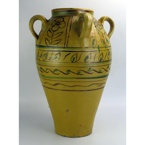 1065 - A large Arabic pottery khablya (storage jar) of ovoid form with four ring handles, and banded polych... 