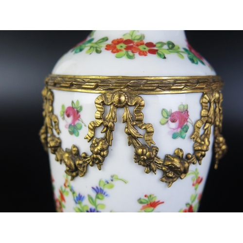 1077 - A Sevres porcelain and gilt metal mounted vase of ovoid form, with painted floral garland decoration... 