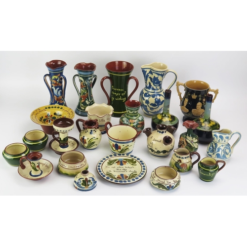 1090 - A collection of Torquay pottery wares, includes jugs, vases, chamberstick, and twin handled vase com... 